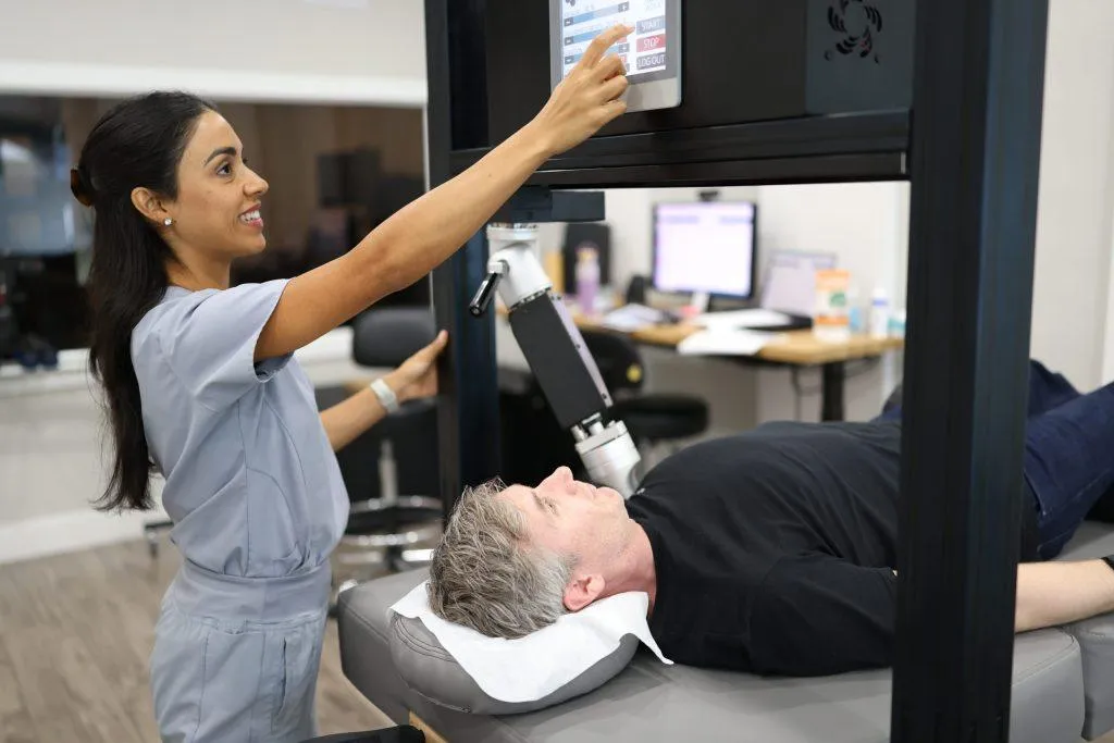 TheraMax therapist using robotic therapy device with patient